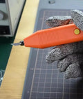 Close-up of Handheld 35 Khz Ultrasonic Cutting Knife for 3D Resin and PLA Models in a gloved hand, showing the sharp blade.