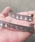 Close-up of two Six Pack U Shape Crystal Glass Drawer Pull Knobs For Cabinets And Dressers with Zinc Alloy Base in a hand.