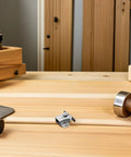 12 Pack Stainless Steel Double Roller Catch Latches for Drawers and Cabinet Doors on wooden desk