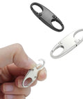 Ultra Durable Mini Carabiner Clips 4 Pack For Zippers, black and silver clips held by hand, showing zinc alloy material