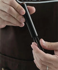 No Fuss WDT Needle Tool For Espresso Brewing retractable needle being held, showcasing sleek design and usability.