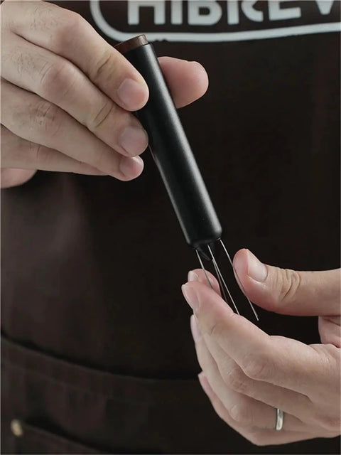 No Fuss WDT Needle Tool For Espresso Brewing retractable needle being held, showcasing sleek design and usability.