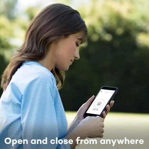 Woman using app on phone to control Smart Garage Control Sensor Kit for a second garage door opener.