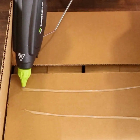 Pro Grade High Temp Hot Glue Gun 220 Watt Heavy Duty Full Size for Industrial Projects, Construction, and Package Sealing in use on cardboard
