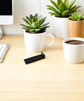 Rock Solid Under Desk Keyboard Drawer Slide Bracket Featuring Legit Secure Fit And Buttery Smooth Gliding With No Sweat Adjustments on a desk with plants.