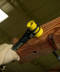 Six In One Lineman's Ratcheting Wrench With Bolt Through Design and Bright Yellow Socket on wooden utility pole