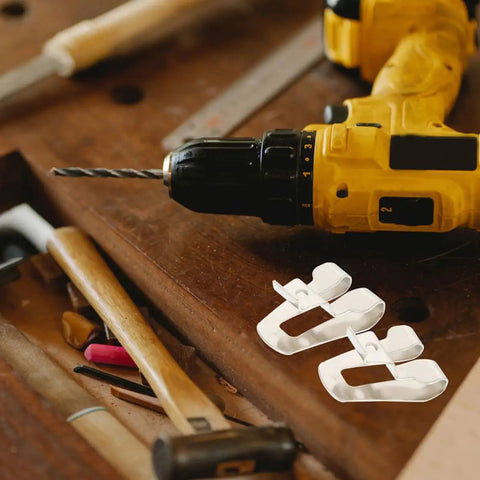 Heavy Duty Steel Belt Clip Hooks For Drill Drivers With Screws Rugged Tool Belt Clips For Secure On Site Tool Carry Rust Resistant Durable Replacement Clips That Stand Up To Tough Worksites., white steel replacement belt clips beside a drill driver on a workbench