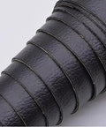 Rolled sheets of black self adhesive leather repair tape 54 by 20 inch for couches sofas chairs car seats furniture and handbags.