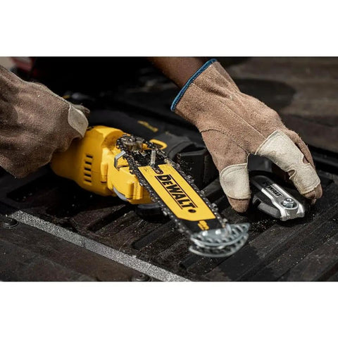 Black and yellow Cordless Pruning Chainsaw 20V 8 Inch For Quick Yard Trims, Lightweight One Hand Comfort Grip, DCCS623B Model in use