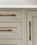Antique Brass Heavy Duty Cabinet Pulls Ten Pack With 3 Inch Hole Center showing on kitchen drawers and doors, vintage hardware.