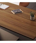 Sit Stand Desk With Premium Ash Wood Surface, Super Spacious Home Office Workstation Featuring Integrated Monitor Shelf, Versatile Gaming And Writing Table For Lazy Nights Or Serious Hustle, close-up of ash wood top with planner, notebook, and plant.