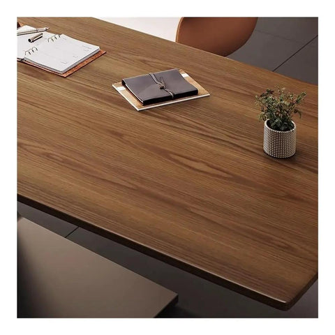 Sit Stand Desk With Premium Ash Wood Surface, Super Spacious Home Office Workstation Featuring Integrated Monitor Shelf, Versatile Gaming And Writing Table For Lazy Nights Or Serious Hustle, close-up of ash wood top with planner, notebook, and plant.