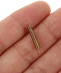Clock Tension Springs Replacement Kit for Wall Clocks and Alarm Clocks, showing alloy extension spring on a hand