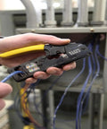 Person using compact ratcheting modular crimper from ProTech Data Kit For Twisted Pair Cabling on wiring panel.