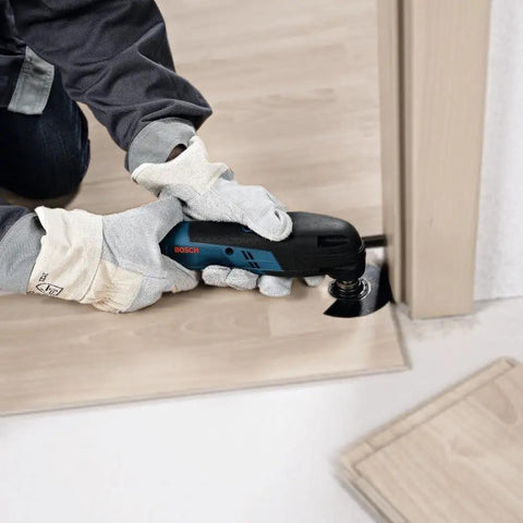 Person using 12V Max EC Brushless Starlock Oscillating Multi Tool Bare Tool with 3-D Starlock Interface for flush cut in wood panel