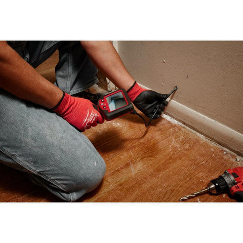 Person using MSpector 4 Foot Inspection Camera Borescope With 4.3 Inch LCD And 640x480 Video, 7.7 mm Shaft to inspect wall