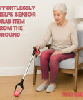 Senior woman using Foldable 32 Inch Grabber Reacher For Seniors With Rotatable Clamp Head And Non Slip Grip Lightweight Arm Extension Pickup Tool For Easy Reach To High Shelves Under Furniture And Tight Spaces to pick up an item from the floor while seated.