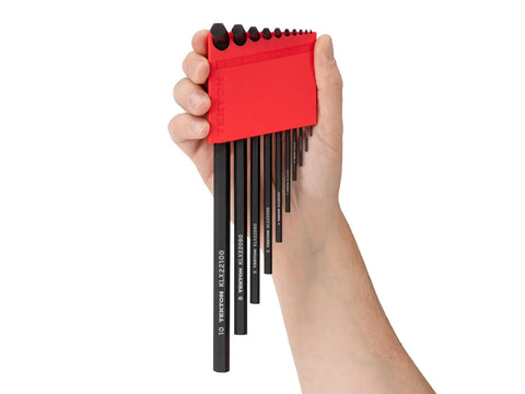 Hand holding Flat End Hex L Key Set 23-Piece With Tight Fit For Fasteners And Narrow Tolerances in red holder, black keys visible.