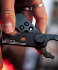 Close-up of All In One Bike Chain Tool With Quick Link Pliers showing bottle opener and multitool parts for repairs