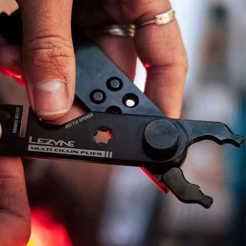 Close-up of All In One Bike Chain Tool With Quick Link Pliers showing bottle opener and multitool parts for repairs
