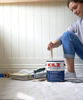 Person preparing to paint with Restoration Primer Interior Sealer And Stainblocker, Water Based, Odor Blocking, 1 Gallon can.