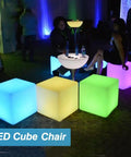 16-Inch Cordless LED Cube Light With Removable Panels glowing in blue, yellow, and green hues at a party setting.