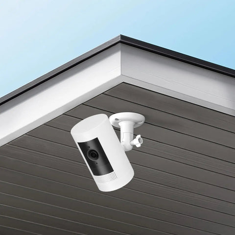 2 Pack No Drill Camera Wall Mount Bracket For Ring And Wyze Security Cameras installed on a ceiling for outdoor surveillance use.