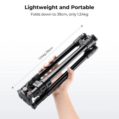Lightweight 64 Inch Camera Tripod With 360 Degree Ball Head And Smartphone Clip folded to 39.5 cm, held in hand.