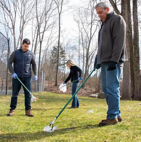 People using 36 inch reacher grabber tool for yard cleanup, showcasing ergonomic grip and magnet for easy trash pickup.