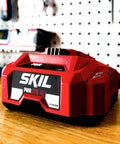 Power Up Fast PWR Jump 150W Charger for 40V Batteries on workbench with LED status lights, PWR Core 40 System