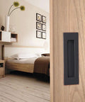 Flush Pull Handle Set 6 Inch Rectangular Oil Rubbed Bronze on wooden sliding barn door in modern bedroom setup