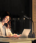 Woman using a laptop illuminated by LED Desk Lamp With USB Charging Port And Pen Holder, Dope Flexible Gooseneck Study Light.