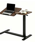 Solid Mobile Standing Desk With Pneumatic Lift And Tilt Top, Smooth Swivel Casters, Heavy Duty Steel Frame Walnut Laptop Workstation at an angle with a laptop and book.