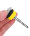 Hand holding a sanding disc tool with yellow backing, compatible with Get Your Hands On This Awesome Set Of 100pcs Sanding Discs With Grits From 100 To 3000 For Smooth Drilling And Shiny Finishes That Last.