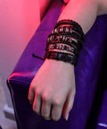 Close-up of Badass Six Piece Braided Leather Bracelet Set For Men And Women Adjustable Hemp Rope Wristbands With Classic Skull Charm Punk Rock Style.