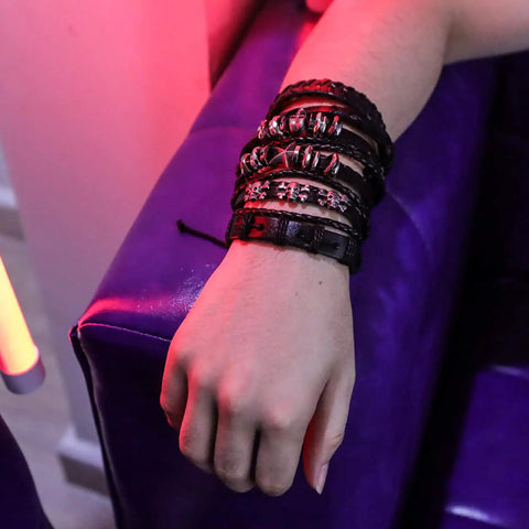 Close-up of Badass Six Piece Braided Leather Bracelet Set For Men And Women Adjustable Hemp Rope Wristbands With Classic Skull Charm Punk Rock Style.