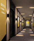 Modern Led Outdoor Wall Sconce,2-Pack 20w Updown Wall Wash Light,Black Metal Ip65 illuminating a stylish hallway with art.