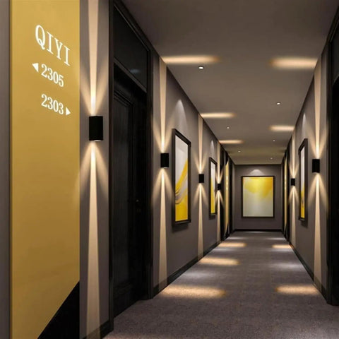 Modern Led Outdoor Wall Sconce,2-Pack 20w Updown Wall Wash Light,Black Metal Ip65 illuminating a stylish hallway with art.
