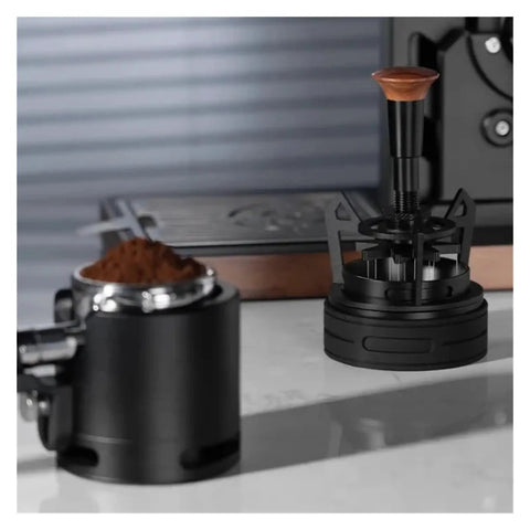 Smooth Operator Espresso Rotary WDT Tool And Coffee Stirrer With Built In Dosing Funnel Stand For Even Powder Distribution and Knockout Barista Shots At 54mm on a countertop with ground coffee.