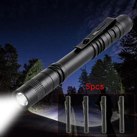 Five Pack Pen Light Flashlights With Clip Ultra Bright Q5 LED Mini Pocket Flashlights illuminating a path at night