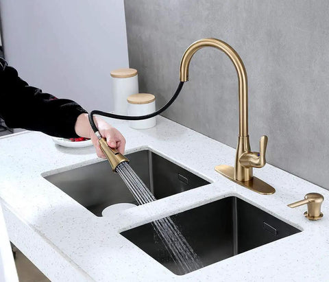 Brushed Gold Kitchen Faucet With Pull Down Sprayer And Soap Dispenser, Deck Plate Included, in use over dual sinks