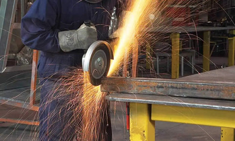 Worker using an angle grinder with Cut Off Wheel Pack Of 25 For Angle Grinders, Beefy Performance Abrasive Wheel Delivers Fast Clean Cuts