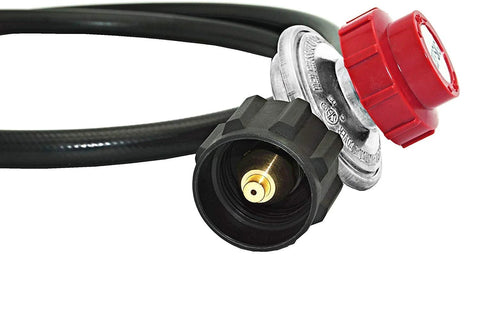 Propane regulator and hose close-up: red knob on metal regulator with brass outlet and black hose.