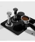 Pro Grade Stainless Steel Espresso Tamper Kit With Auto Rebound For 51 53 And 58 Mm Portafilters arranged on a black mat.