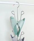 Heavy Duty Stainless Steel Hanging Shoe Rack With Double Nonslip Hooks displaying green and gray slippers securely organized.