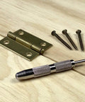 General Tools 806 Jiffy Centering Punch, silver knurled steel, front view with three screws and brass hinge plates.