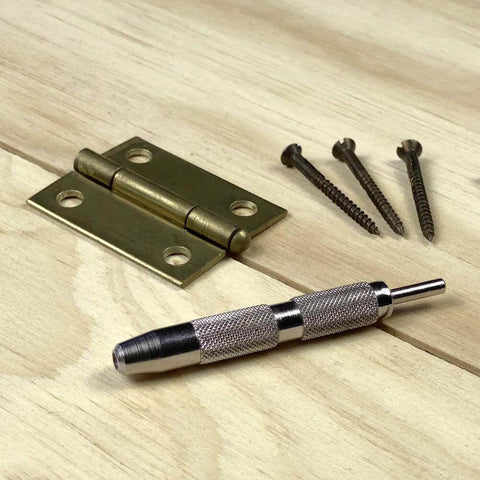 General Tools 806 Jiffy Centering Punch, silver knurled steel, front view with three screws and brass hinge plates.