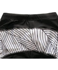 Black leggings with white geometric pattern waistband, close-up view