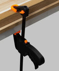 Dual Size Bar Clamps Set 4 Inch And 8 Inch Quick Grip Trigger Clamps One Handed Ratchet Clamp securing wood on workbench