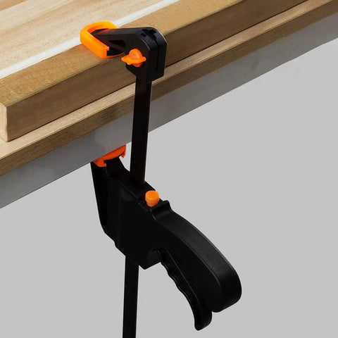 Dual Size Bar Clamps Set 4 Inch And 8 Inch Quick Grip Trigger Clamps One Handed Ratchet Clamp securing wood on workbench